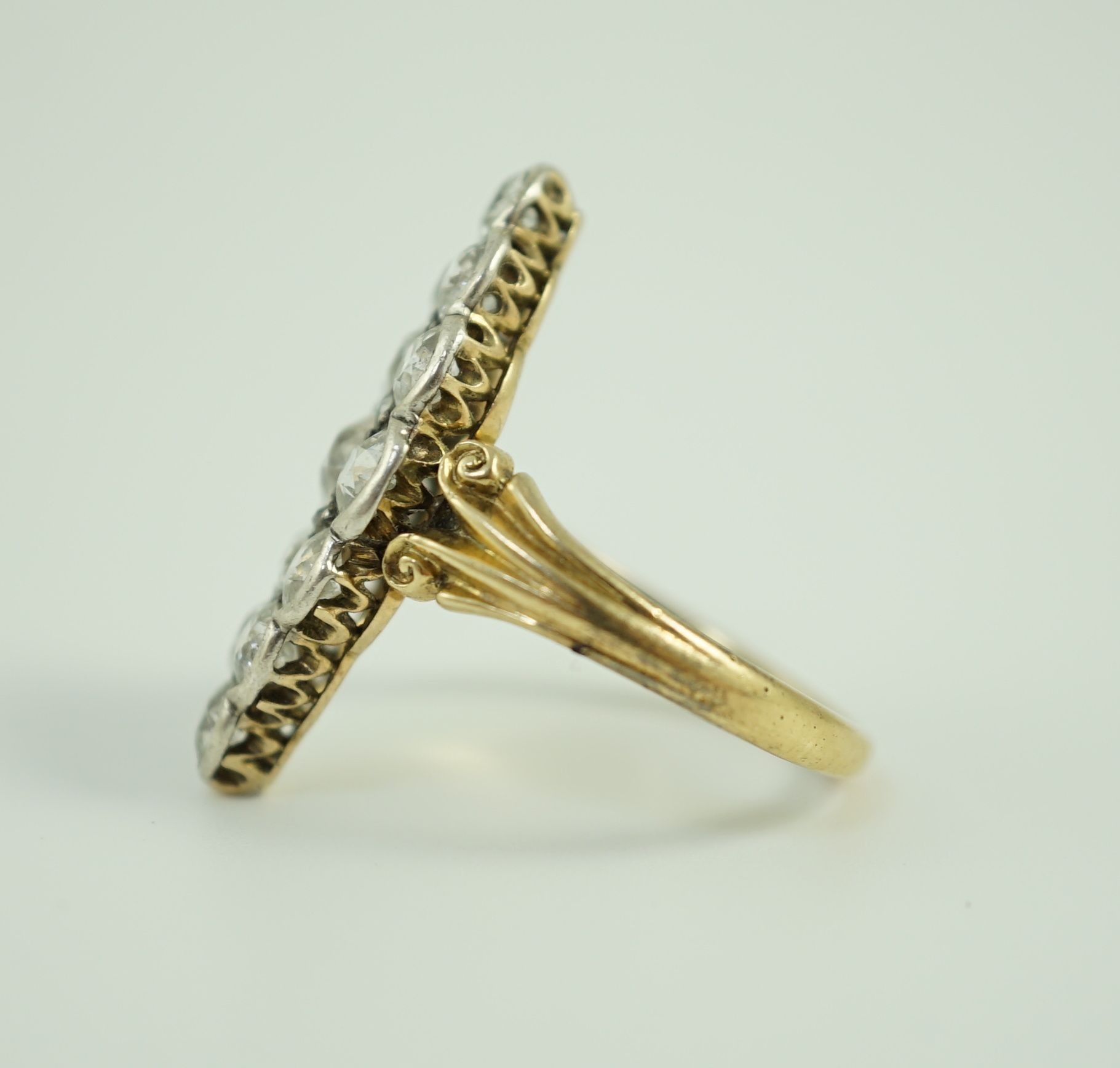 A Victorian style 18ct gold and fifteen stone diamond set marquise cluster dress ring